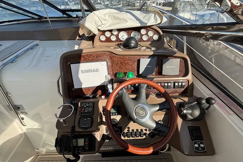 Slide: The Image of Helm of 2005 Regal Commodore 4260 with navigation equipment and controls. - 4