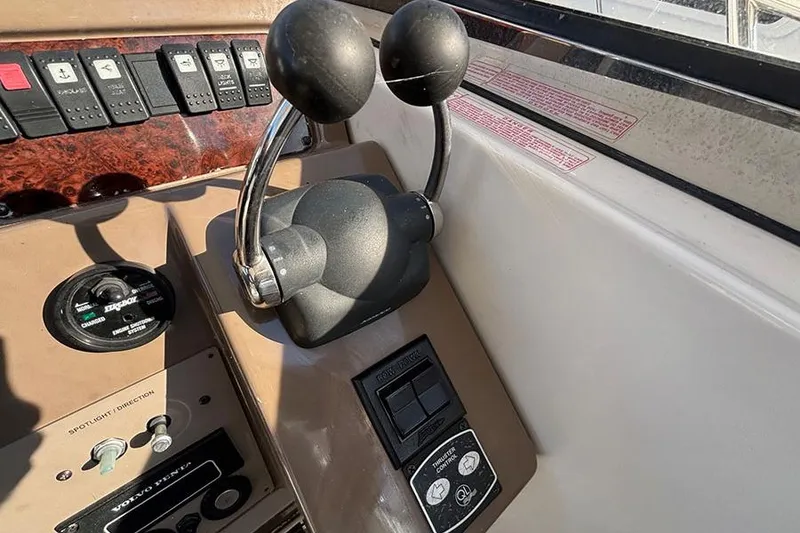 Slide: The Image of Control panel of a 2005 Regal Commodore 4260 boat with throttle levers. - 5