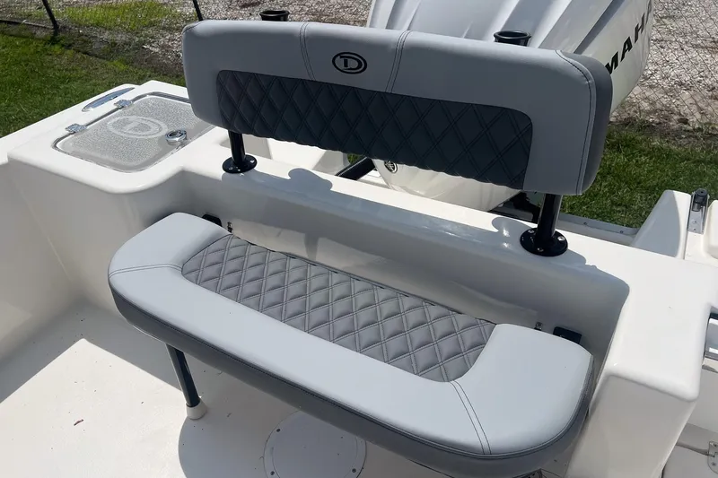 Slide: The Image of 2026 Defiance Catalina 240 boat seating with diamond-stitched upholstery and Yamaha engine. - 10