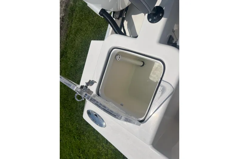 Slide: The Image of Open storage compartment on 2026 Defiance Catalina 240 boat, featuring a clear lid. - 11