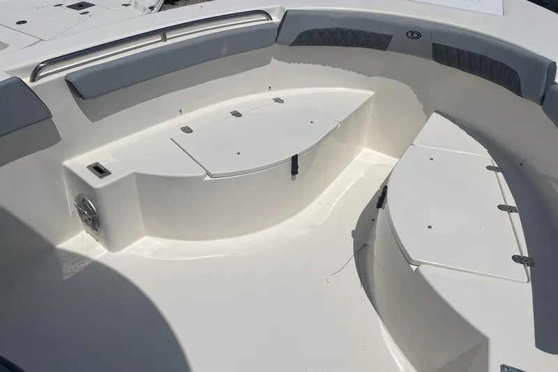 Slide: The Image of 2026 Defiance Catalina 240 boat interior with cushioned seating and storage compartments. - 15