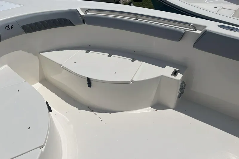 Slide: The Image of Interior view of 2026 Defiance Catalina 240 boat, featuring seating and storage area. - 16