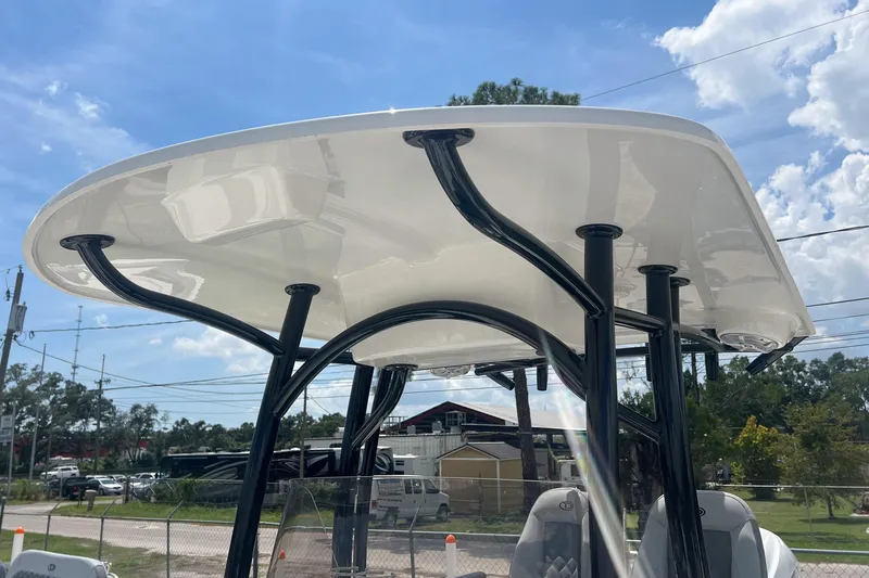 Slide: The Image of 2026 Defiance Catalina 240 boat with sleek T-top design under a clear blue sky. - 19