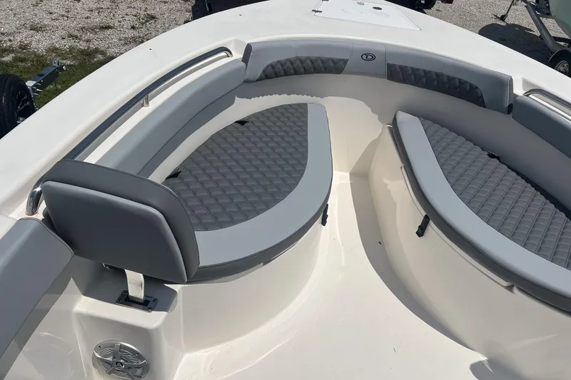 Slide: The Image of 2026 Defiance Catalina 240 boat interior with gray cushioned seating and sleek design. - 21