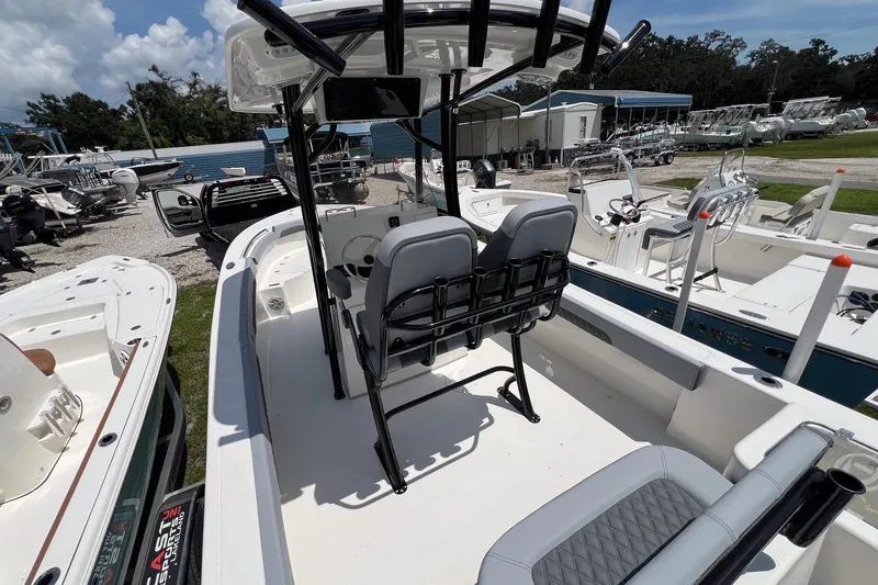 Slide: The Image of 2026 Defiance Catalina 240 boat with dual seats and center console in a marina. - 26