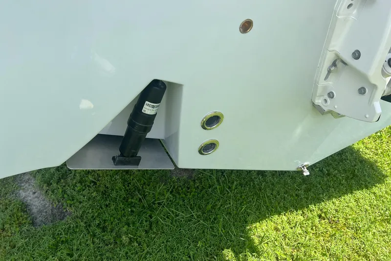 Slide: The Image of 2026 Defiance Catalina 240 boat hull detail with hydraulic components on grass. - 27