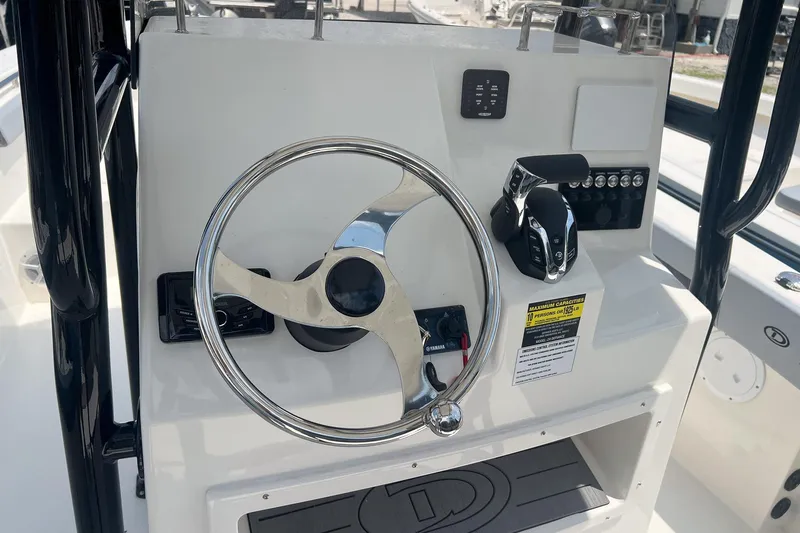Slide: The Image of Steering console of 2026 Defiance Catalina 240 boat with chrome wheel and controls. - 7