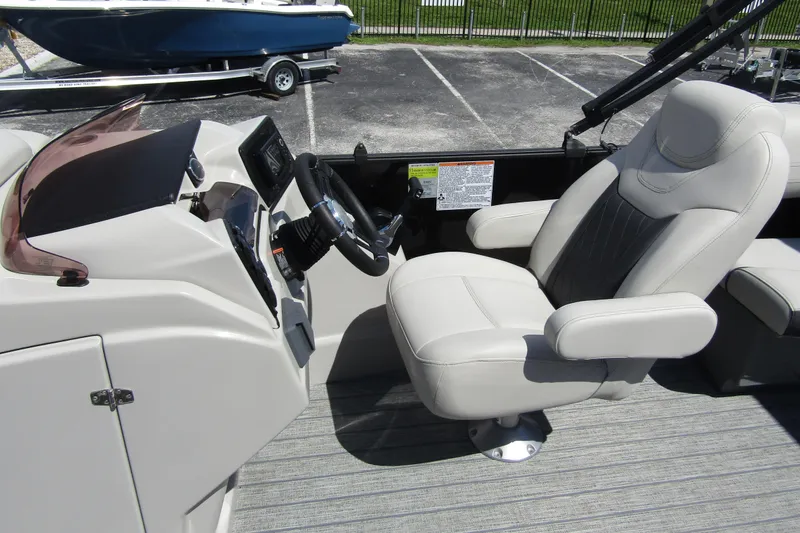 Slide: The Image of 2021 Starcraft SLS 1 boat interior with captain's chair and steering console. - 15