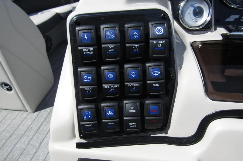 Slide: The Image of Control panel of a 2021 Starcraft SLS 1 boat with labeled switches. - 18