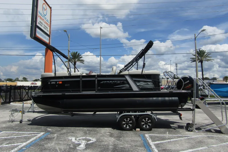 Slide: The Image of 2021 Starcraft SLS 1 pontoon boat on trailer at Nautical Ventures dealership. - 2