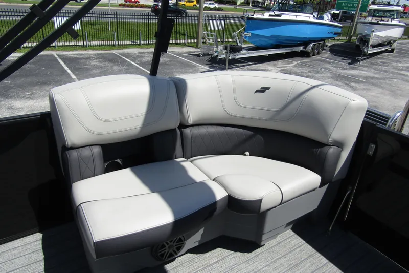 Slide: The Image of 2021 Starcraft SLS 1 boat interior with plush seating in a showroom. - 22