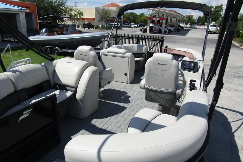 Slide: The Image of 2021 Starcraft SLS 1 pontoon boat interior with plush seating and modern dashboard. - 28