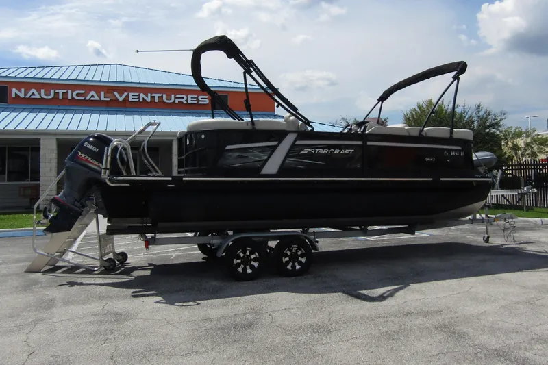 Slide: The Image of 2021 Starcraft SLS 1 pontoon boat on trailer at Nautical Ventures dealership. - 5