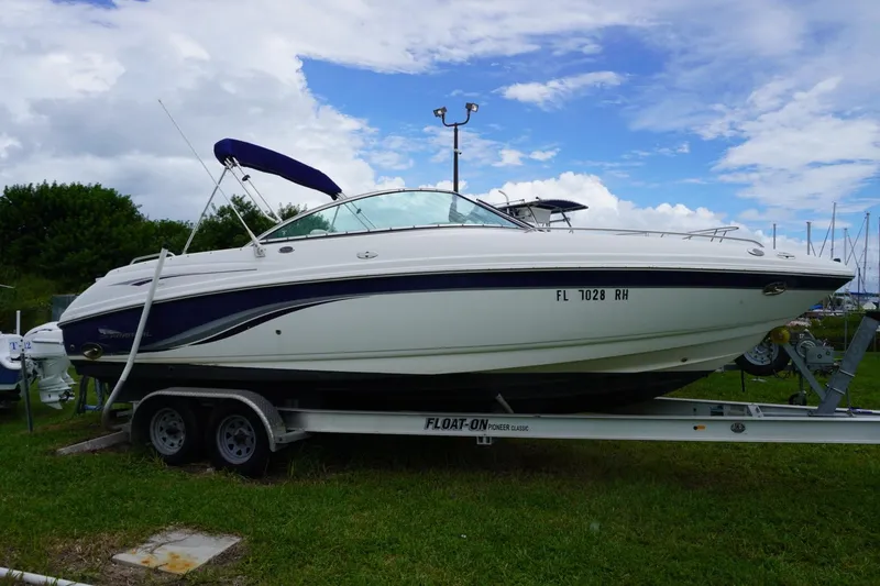 Slide: The Image of 2003 Chaparral 230 SSi boat on trailer, parked on grass under cloudy sky. - 1