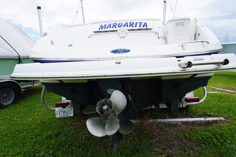Slide: The Image of 2003 Chaparral 230 SSi boat named "Margarita" on grass, rear view with propeller visible. - 10