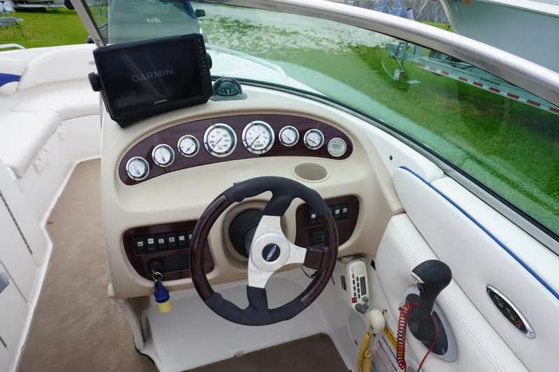 Slide: The Image of 2003 Chaparral 230 SSi boat dashboard with Garmin GPS and steering wheel. - 15