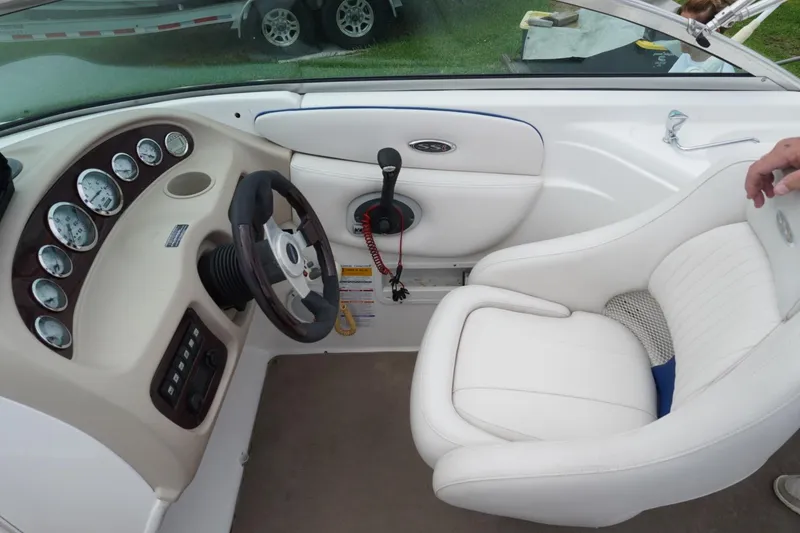 Slide: The Image of Interior of 2003 Chaparral 230 SSi boat showing steering wheel and dashboard controls. - 16