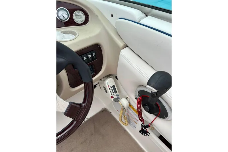 Slide: The Image of 2003 Chaparral 230 SSi boat dashboard with steering wheel and control panel. - 20