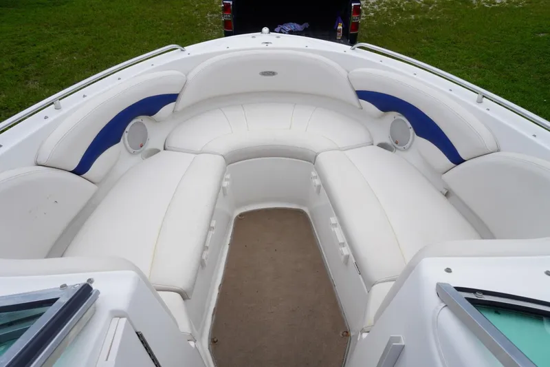 Slide: The Image of 2003 Chaparral 230 SSi boat interior with white and blue seating, spacious and comfortable. - 22