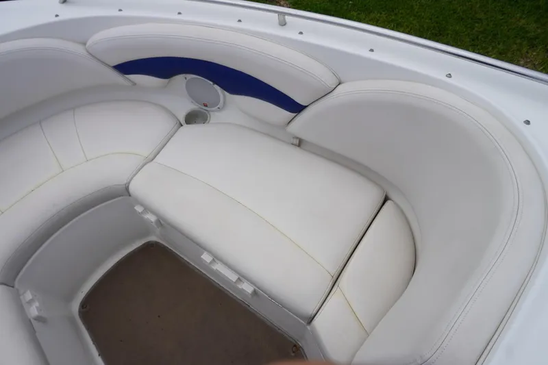 Slide: The Image of 2003 Chaparral 230 SSi boat interior with white cushioned seating and speaker. - 23