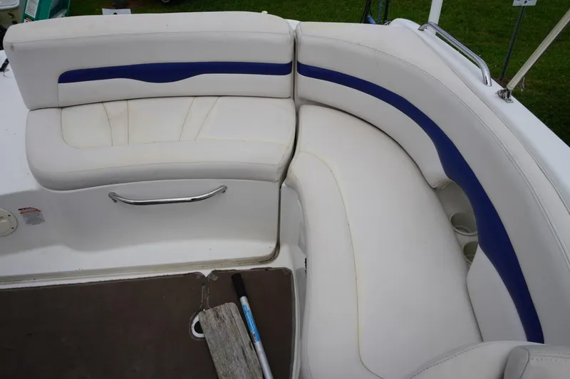 Slide: The Image of 2003 Chaparral 230 SSi boat interior with white and blue cushioned seating. - 24