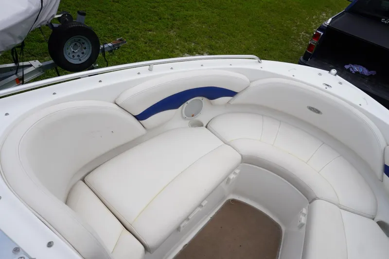 Slide: The Image of 2003 Chaparral 230 SSi boat interior with white cushioned seating and blue accents. - 25
