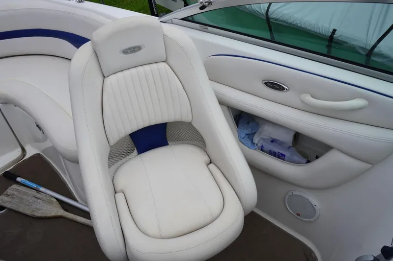 Slide: The Image of 2003 Chaparral 230 SSi boat interior with white seating and storage compartment. - 26