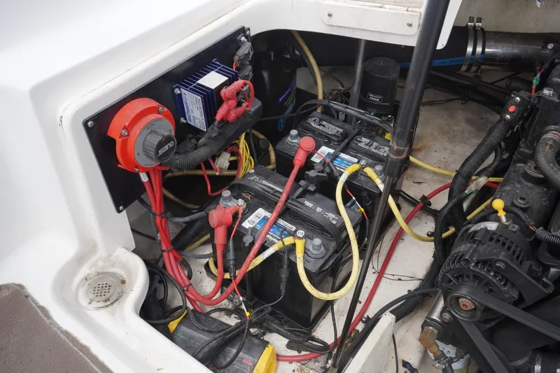 Slide: The Image of Engine compartment of a 2003 Chaparral 230 SSi boat, showing batteries and wiring. - 28