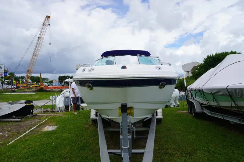 Slide: The Image of 2003 Chaparral 230 SSi boat on trailer, outdoor display with crane in background. - 3