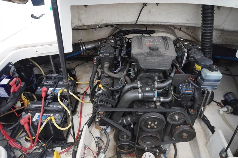 Slide: The Image of Engine compartment of a 2003 Chaparral 230 SSi boat, featuring batteries and wiring. - 31