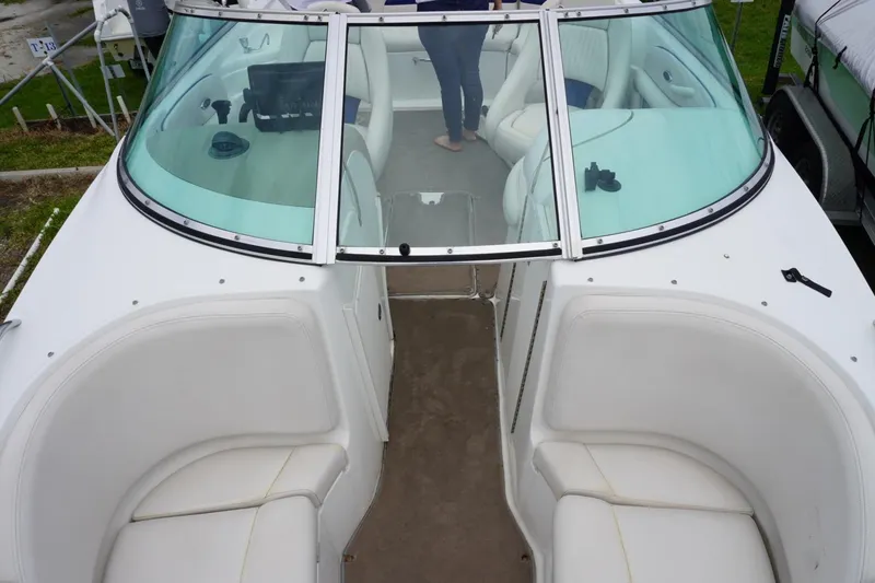 Slide: The Image of 2003 Chaparral 230 SSi boat interior with white seating and windshield view. - 33