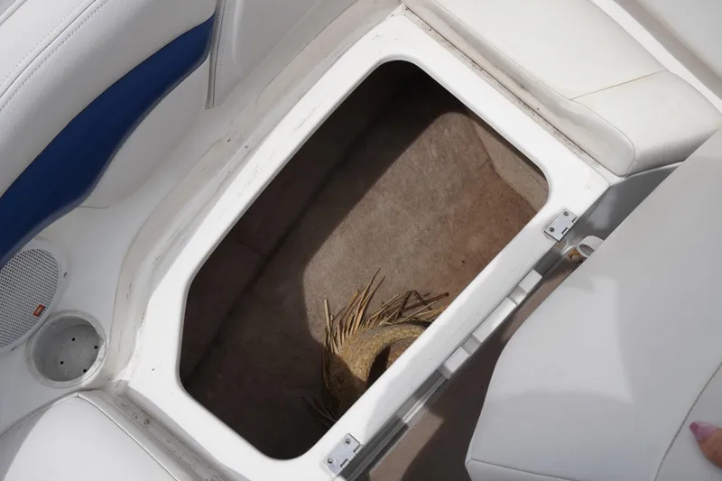 Slide: The Image of Storage compartment in 2003 Chaparral 230 SSi boat with white and blue seating. - 38