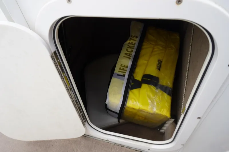 Slide: The Image of Storage compartment on 2003 Chaparral 230 SSi boat with yellow life jackets. - 39