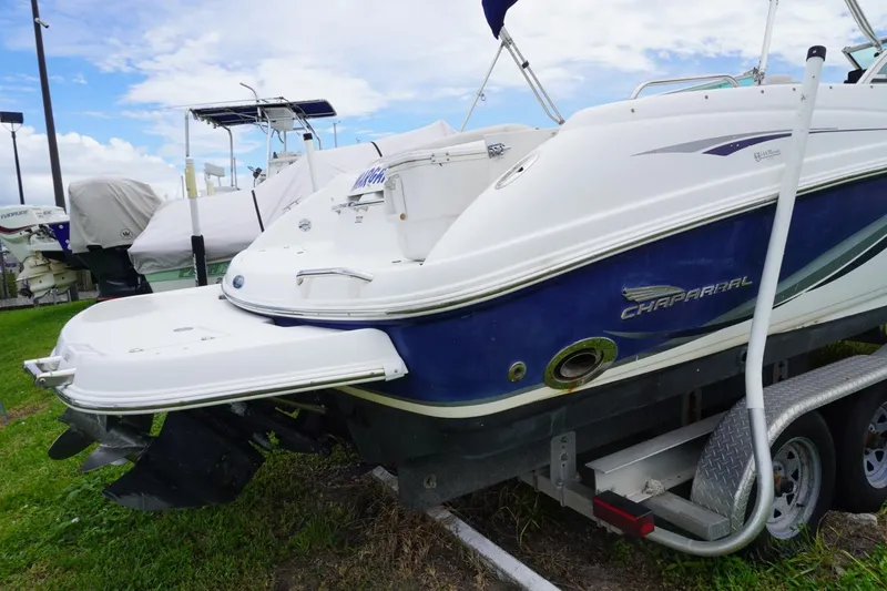 Slide: The Image of 2003 Chaparral 230 SSi boat on trailer, parked outdoors under cloudy sky. - 46
