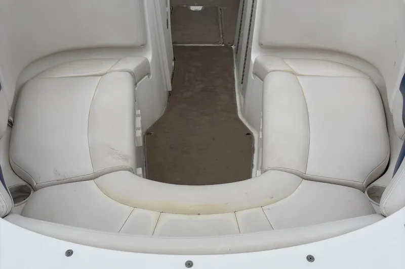 Slide: The Image of 2003 Chaparral 230 SSi boat interior with white cushioned seating. - 47