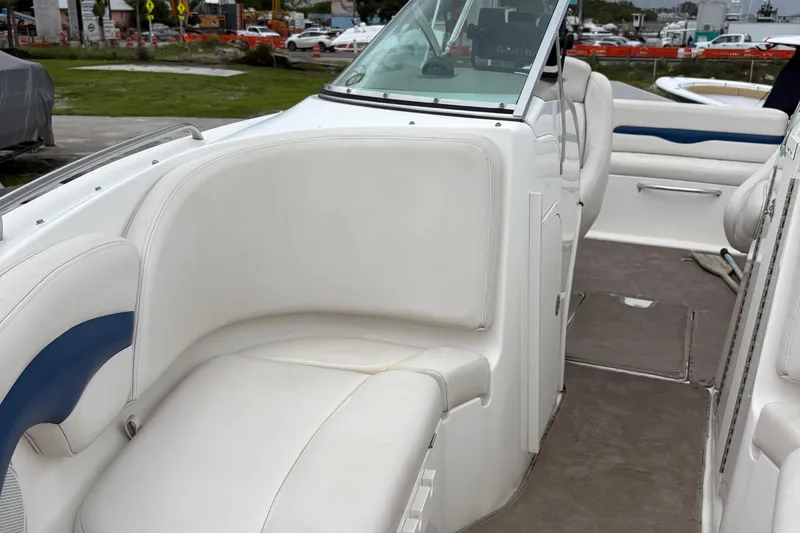 Slide: The Image of 2003 Chaparral 230 SSi boat interior with white seating and dashboard view. - 48