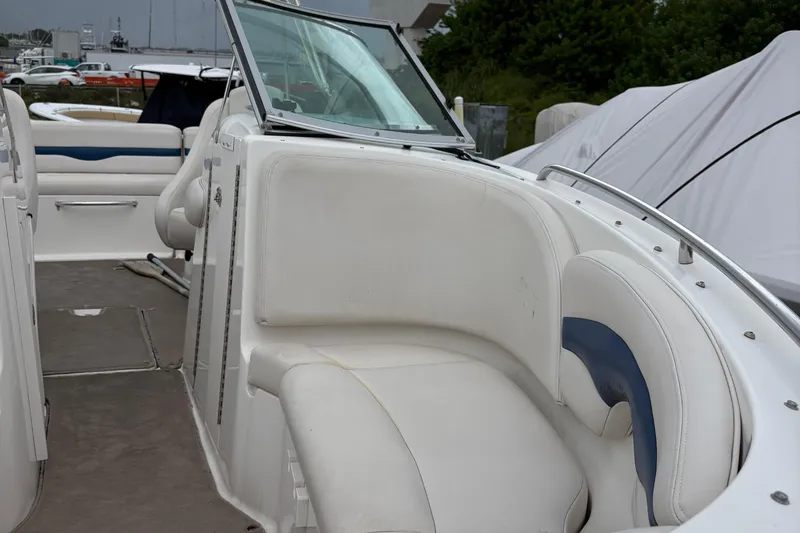 Slide: The Image of 2003 Chaparral 230 SSi boat interior with white seating and windshield. - 49