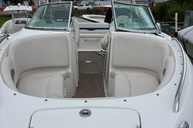 Slide: The Image of 2003 Chaparral 230 SSi boat interior with white seating and windshield. - 50