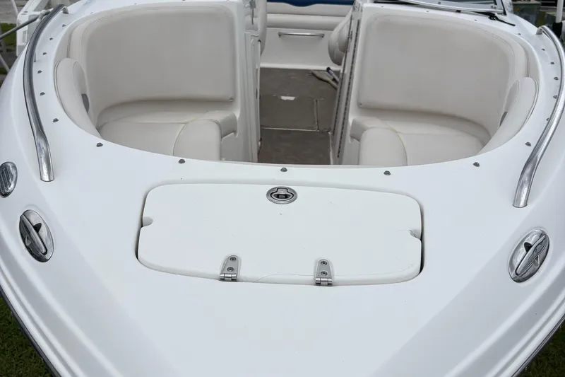 Slide: The Image of 2003 Chaparral 230 SSi boat interior with white seating and storage compartment. - 51