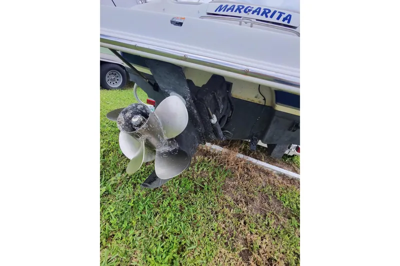 Slide: The Image of 2003 Chaparral 230 SSi boat stern with propeller on grass. - 58