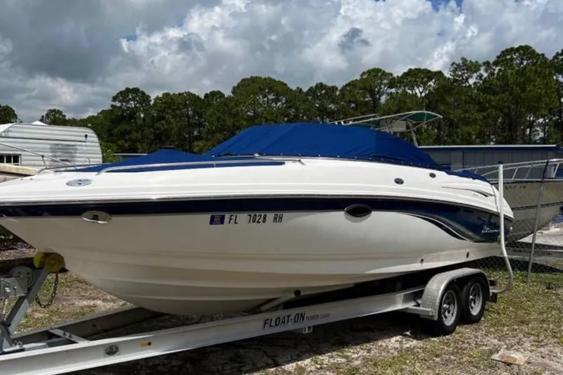 Slide: The Image of 2003 Chaparral 230 SSi boat on trailer, blue cover, outdoor storage. - 6