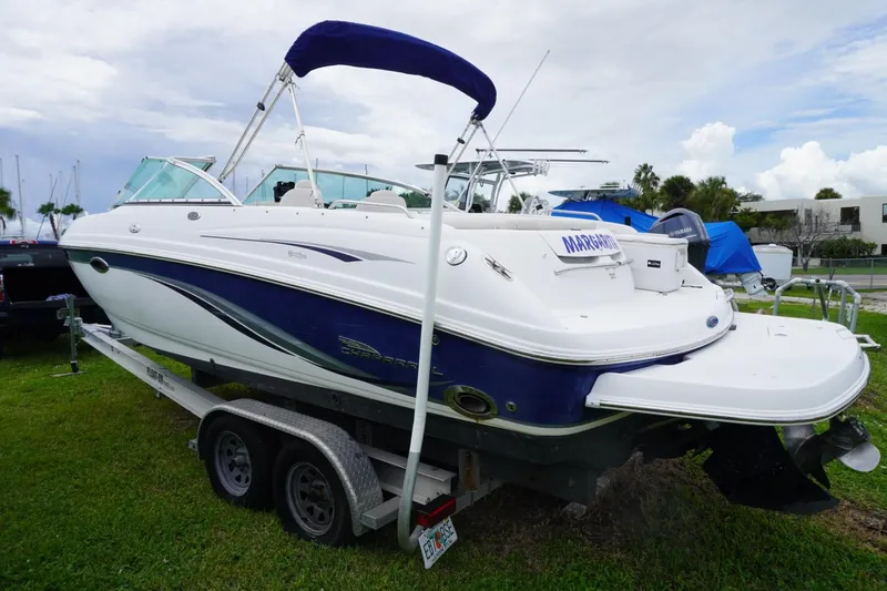 Slide: The Image of 2003 Chaparral 230 SSi boat on trailer, white and blue, parked on grass. - 62