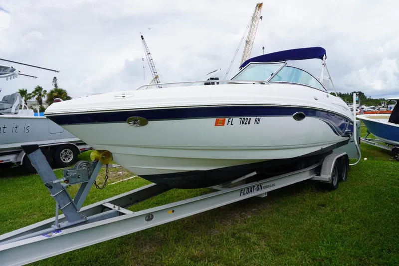 Slide: The Image of 2003 Chaparral 230 SSi boat on trailer, parked on grass with cloudy sky background. - 7
