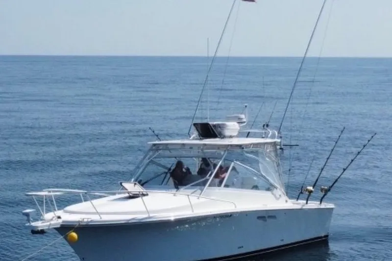 The Image of 2011 Luhrs 30 Open boat on calm ocean waters, equipped for fishing. - 0