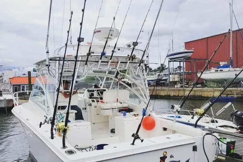 Slide: The Image of 2011 Luhrs 30 Open fishing boat docked with multiple fishing rods. - 1
