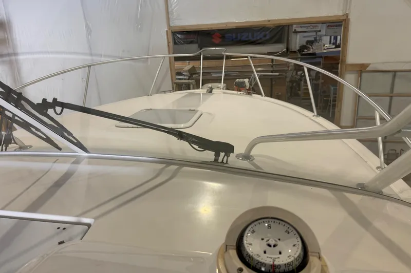 Slide: The Image of 2011 Luhrs 30 Open boat interior with compass and windshield wipers in a workshop. - 13