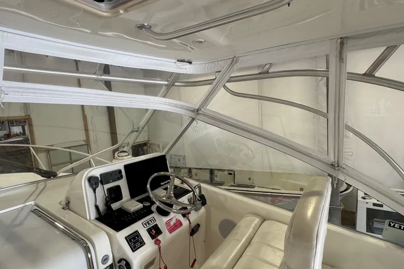 Slide: The Image of 2011 Luhrs 30 Open boat interior with steering wheel and navigation equipment. - 14