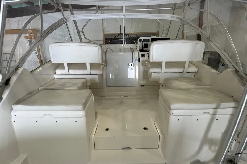 Slide: The Image of 2011 Luhrs 30 Open boat interior with white seating and helm station. - 16