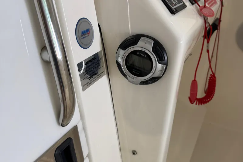 Slide: The Image of 2011 Luhrs 30 Open boat dashboard with Sony stereo and safety warnings. - 19