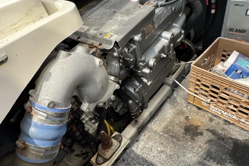 Slide: The Image of Engine compartment of a 2011 Luhrs 30 Open boat, featuring mechanical components and storage. - 21